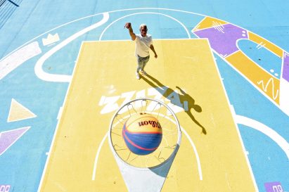 A player shoots a ball into a basketball hoop