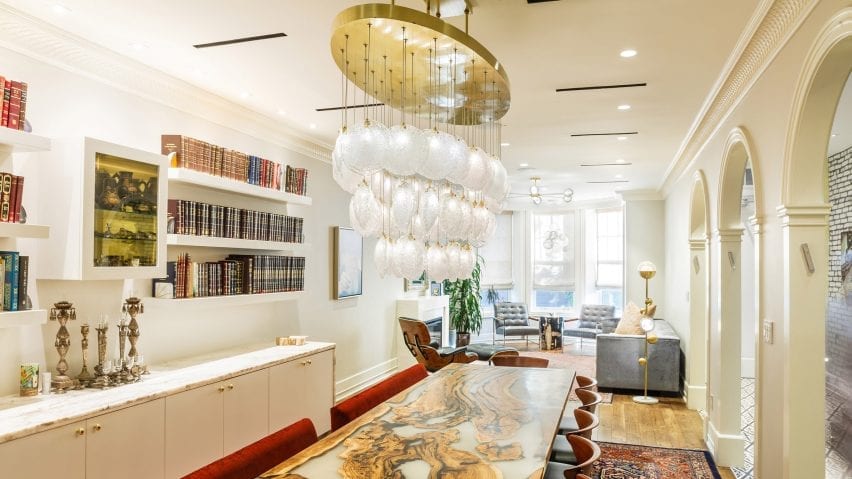 Crystal shell pendant lights hanging above a dining table