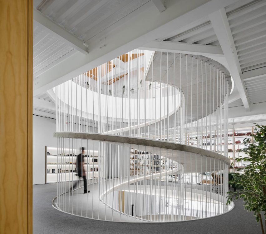 Spiralling concrete ramp in E-goi and Clavel's Kitchen by Paulo Merlini Architects