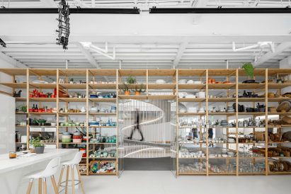 Storage wall filled with colourful ceramics in E-goi and Clavel's Kitchen by Paulo Merlini Architects