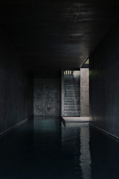 A swimming pool lined with black concrete