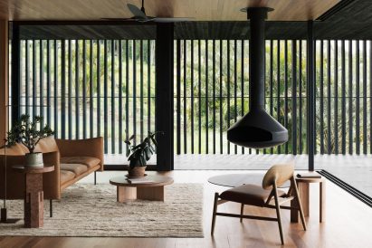 A living room with a suspended fireplace
