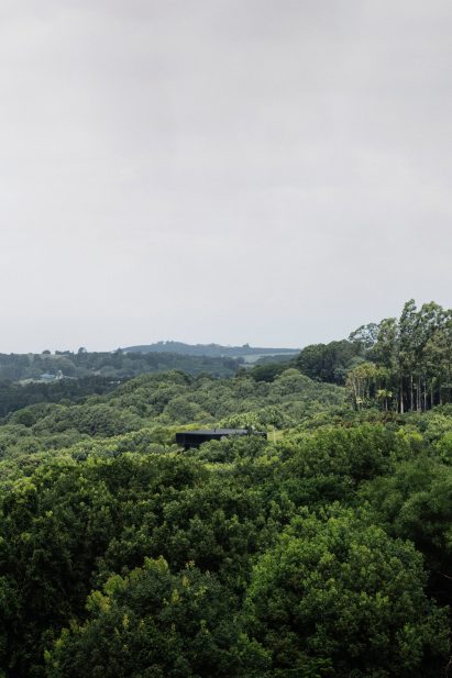 A forested landscape with a secluded house