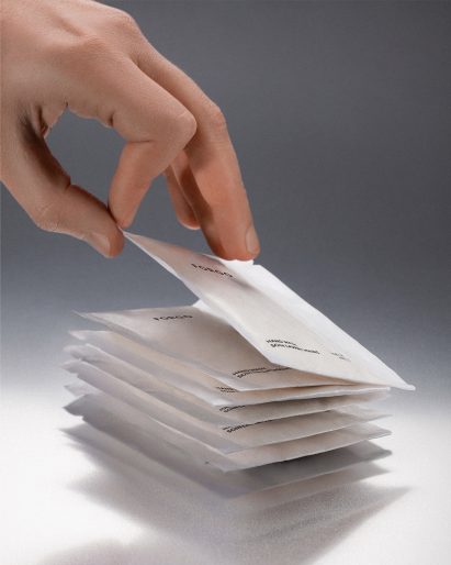 Hand grabbing a refill sachet of powdered soap