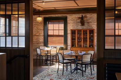 Dining area separated by wood and glass partitions