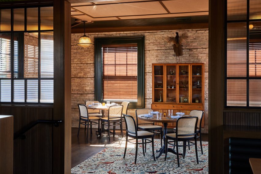 Dining area separated by wood and glass partitions