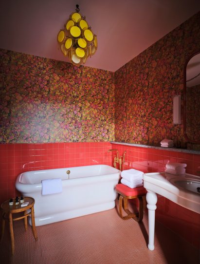 A white bath in a red bathroom