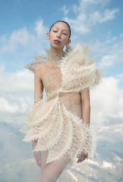 A woman wearing a white cut out dress