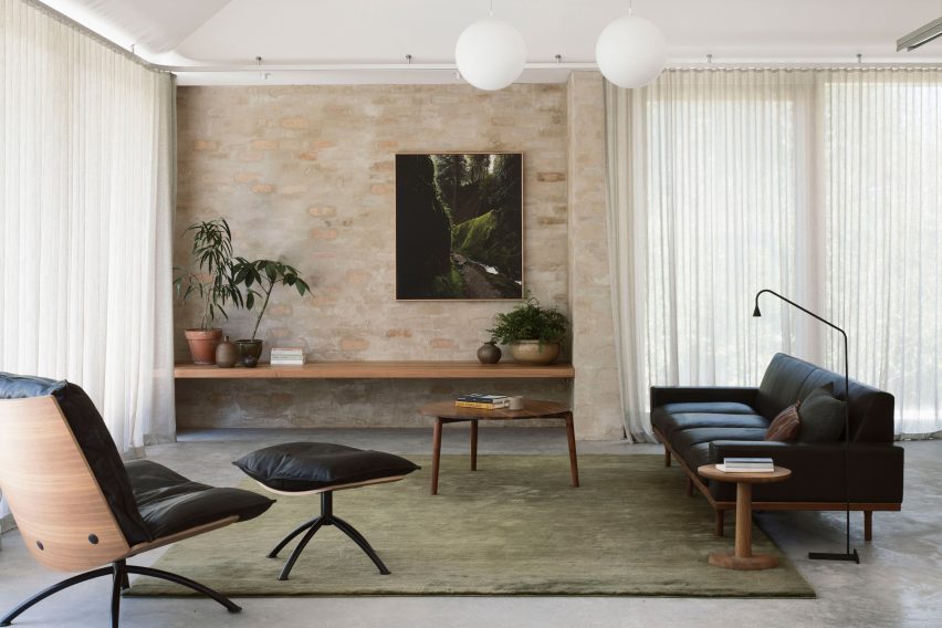 A living room with exposed brick walls