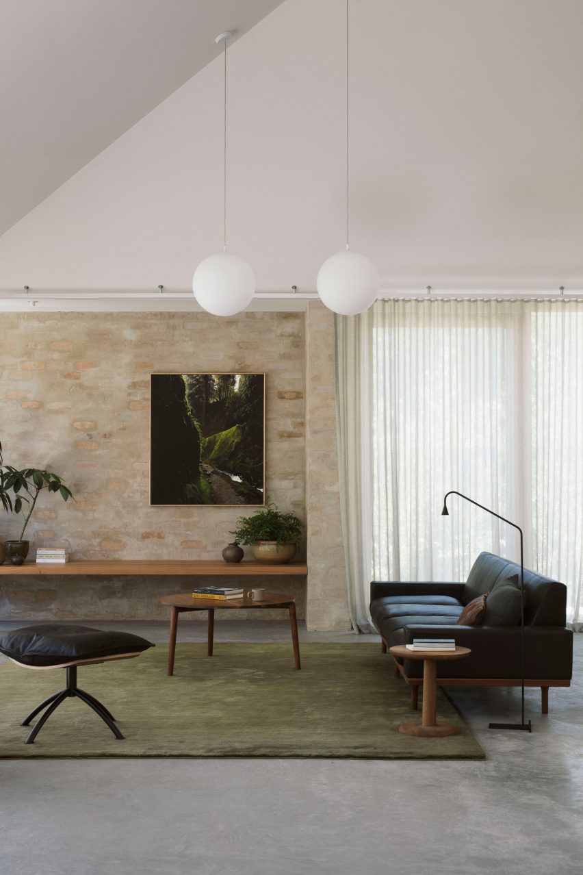 A living room with exposed brick walls