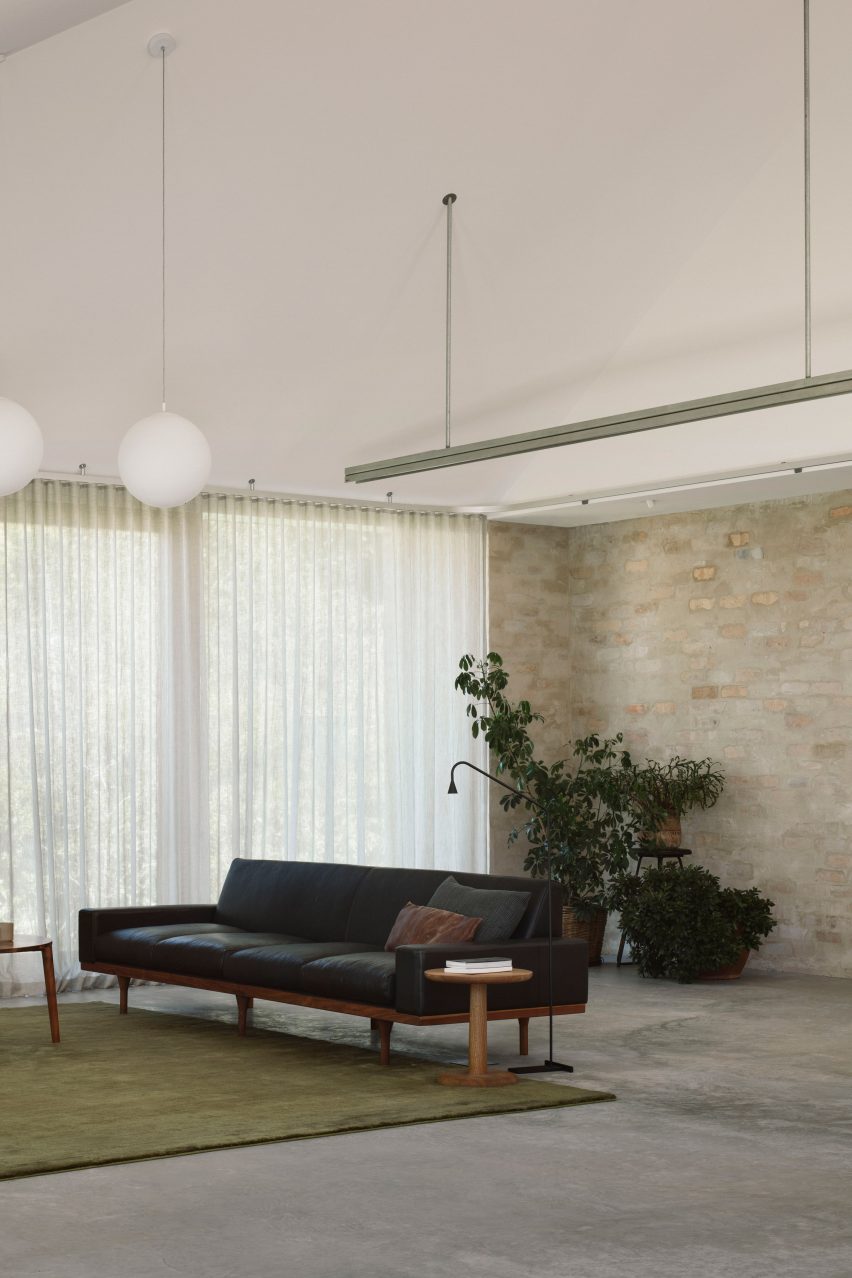 A living room with brick walls and a pitched ceiling