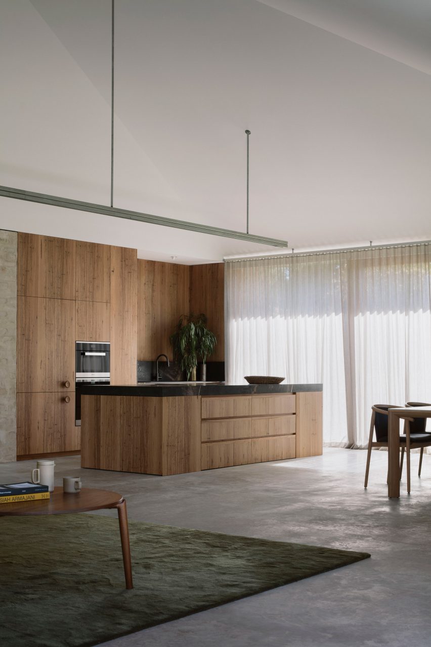 An open-plan kitchen with wooden cabinetry