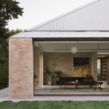 A brick house with a corrugated metal roof
