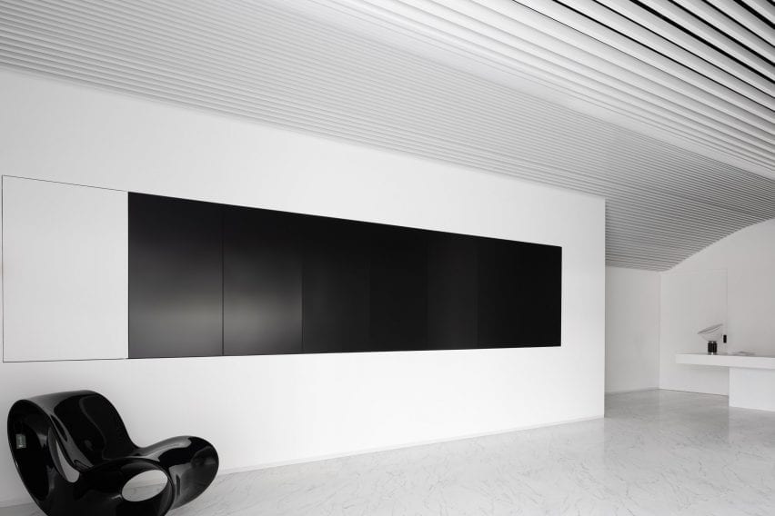 Black art work covers the walls
