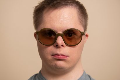 A man wearing rounded Reframd sunglasses