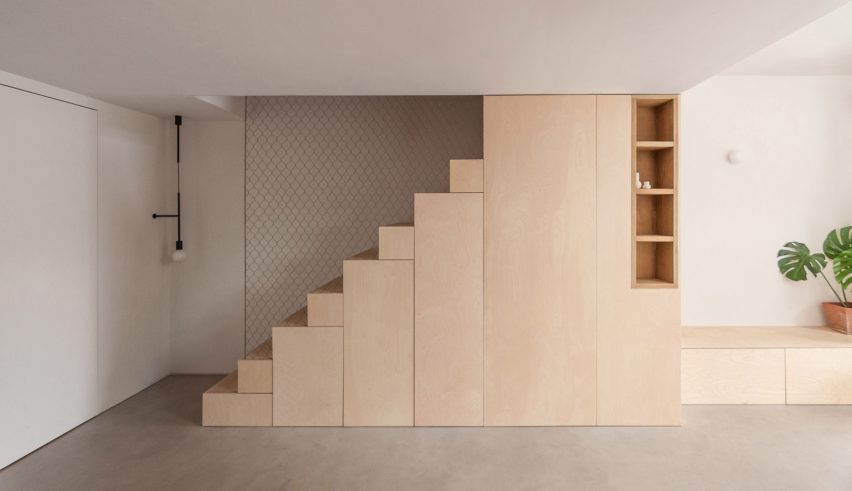 A wooden staircase with inbuilt storage