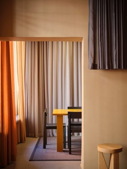 Openings in walls connect different rooms at samsen atelier