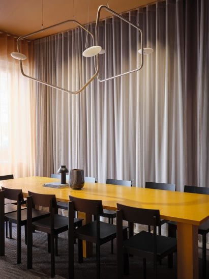 A yellow dining table was placed at the centre of the space
