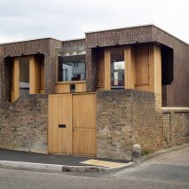 Southwark Brick House peeks above a brick wall in Bermondsey