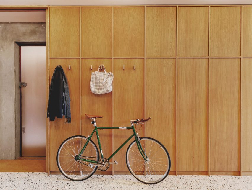 Entrance library with oak cupboards in St John Street warehouse apartment by Emil Eve Architects