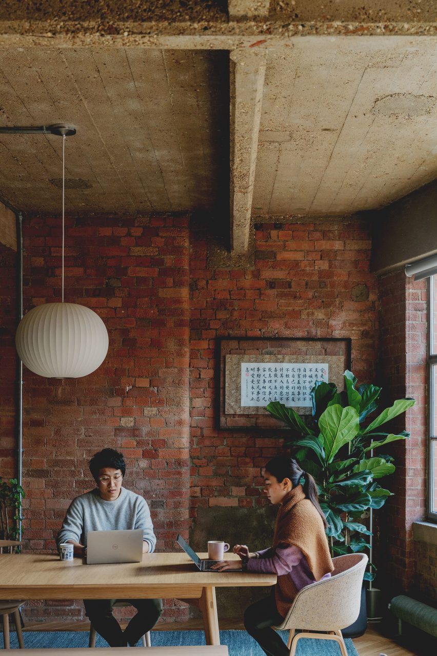 Mike and Jen at the dining table in St John Street warehouse apartment by Emil Eve Architects