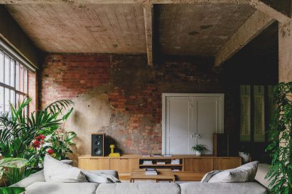 Lounge with custom sideboard in St John Street warehouse apartment by Emil Eve Architects