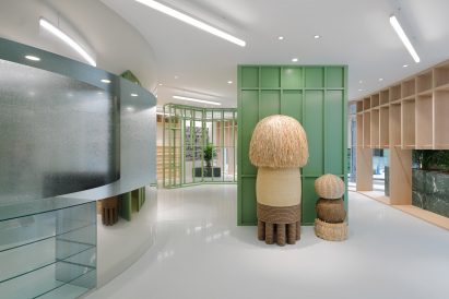 Mirrored counter, mushroom statues and green shelving in Stüssy Shibuya store