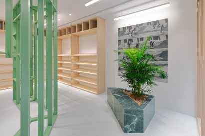 Green and wood shelving with green marble planter in Stüssy Shibuya store