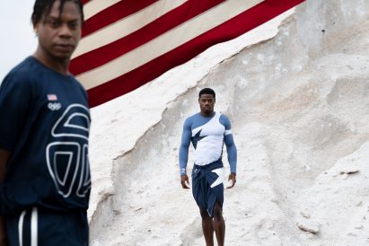 Two men wearing blue and white telfar olympics uniforms