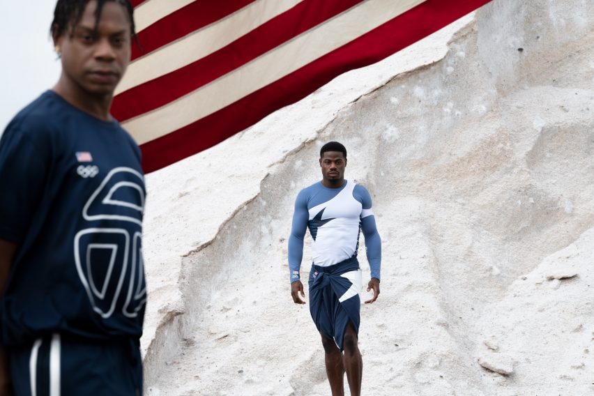 Two men wearing blue and white telfar olympics uniforms