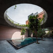 Circular opening above a pool at pink house