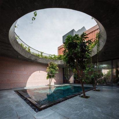 Circular opening above a pool at pink house