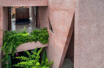 Planted balconies are adjoined to the bedrooms of pink house