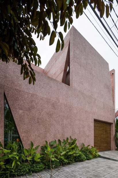 Pink house has a pebble dash exterior