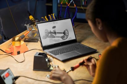 A photograph of a person using a HP workstation at a desk
