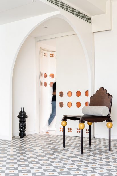 Curved walls and mosaic floors leading to temple in Mumbai apartment