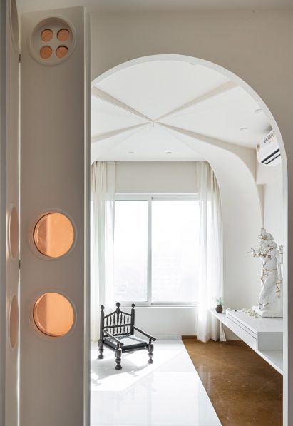 Residential temple interior by The Act of Quad with white marble and stone floors and arched ceiling