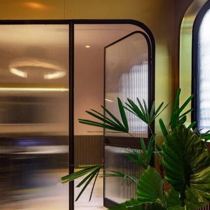 Mexico City office interior features wealth of gold accents and marble