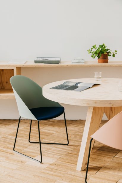 A photograph of a green and navy chair at a table