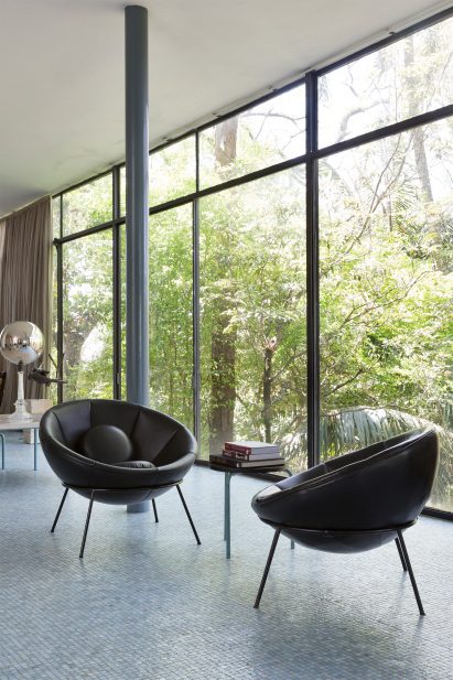 A photograph of two bowl-like chairs in brown