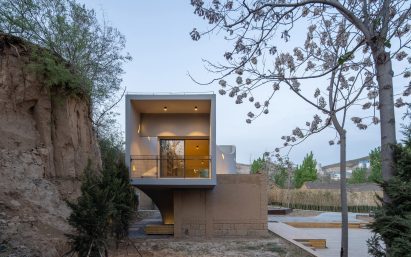 The building's fluid shapes complement the natural forms of the surrounding trees