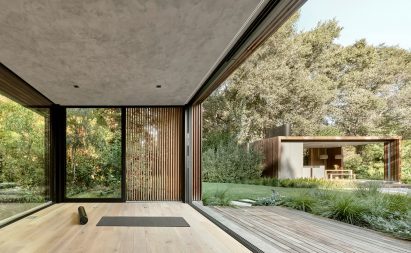 A black yoga mat on the floor inside a pavilion