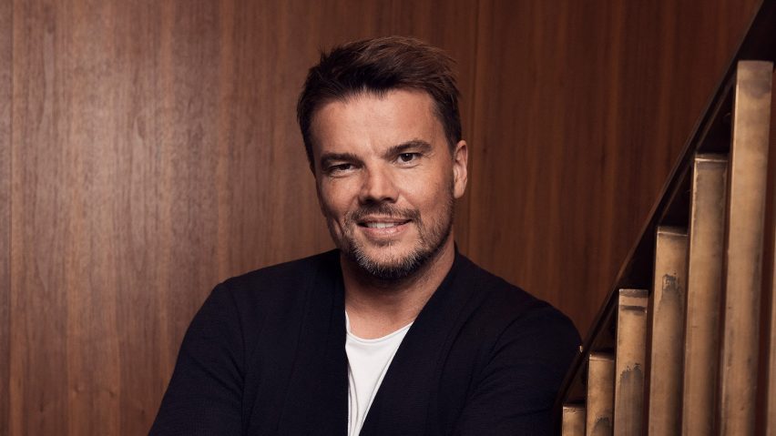 bjarke ingels portrait against wood panelled wall