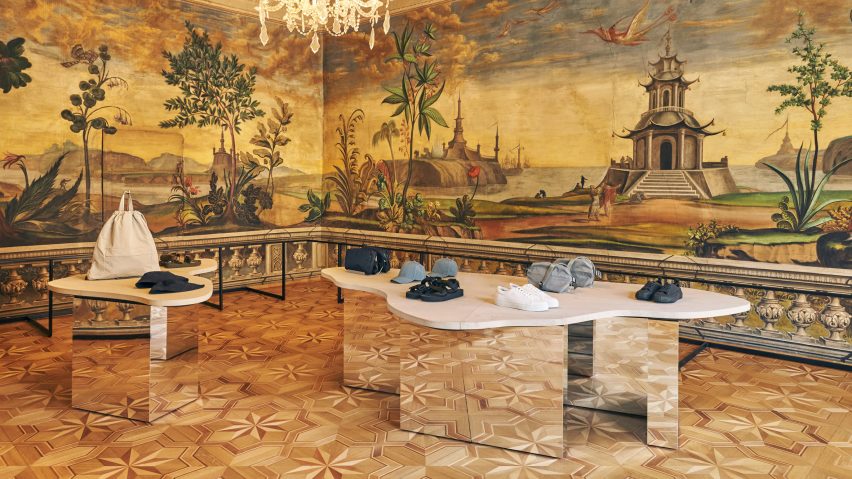Mirrored display tables with stone tops in COS Bolzano store