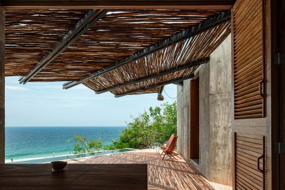 A chair on a deck overlooking the sea