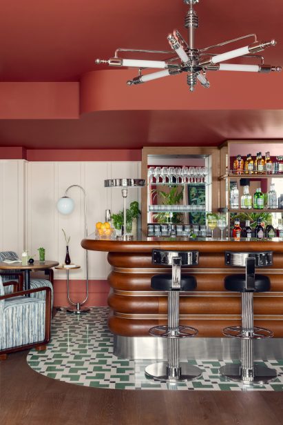 Curved wooden bar and patterned floor in Schwan Locke hotel