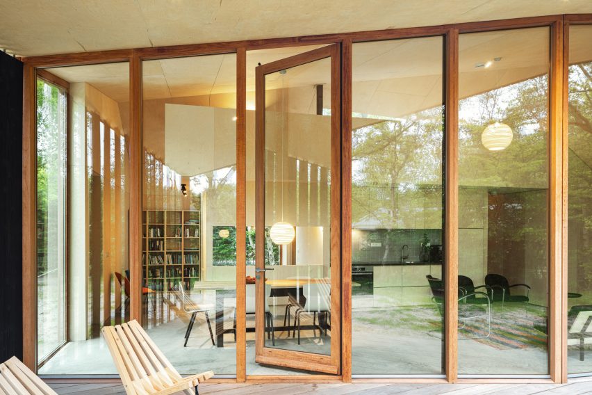 Floor to ceiling glass sliding doors run along the cabin