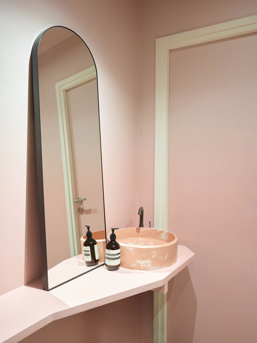 A pink bathroom and mirror
