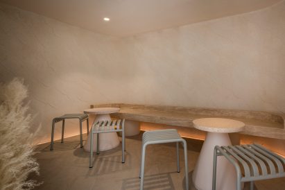 Seats, tables and a bench inside the cafe