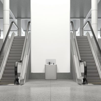 A photograph of a wash pod besides escalators